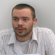 Man with short brown hair, mustache and beard